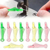 A set of five auto needle threaders in various colors, including green, pink, and yellow, shown against a white background.