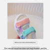 Close-up of pink and teal kids' sandals with wide toe caps shown against a light background.