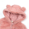 A pink faux fur hooded jacket or romper with a zipper closure.