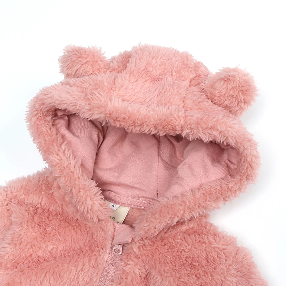 A pink faux fur hooded jacket or romper with a zipper closure.