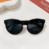 Black polarized sunglasses with a durable frame resting on a white surface.