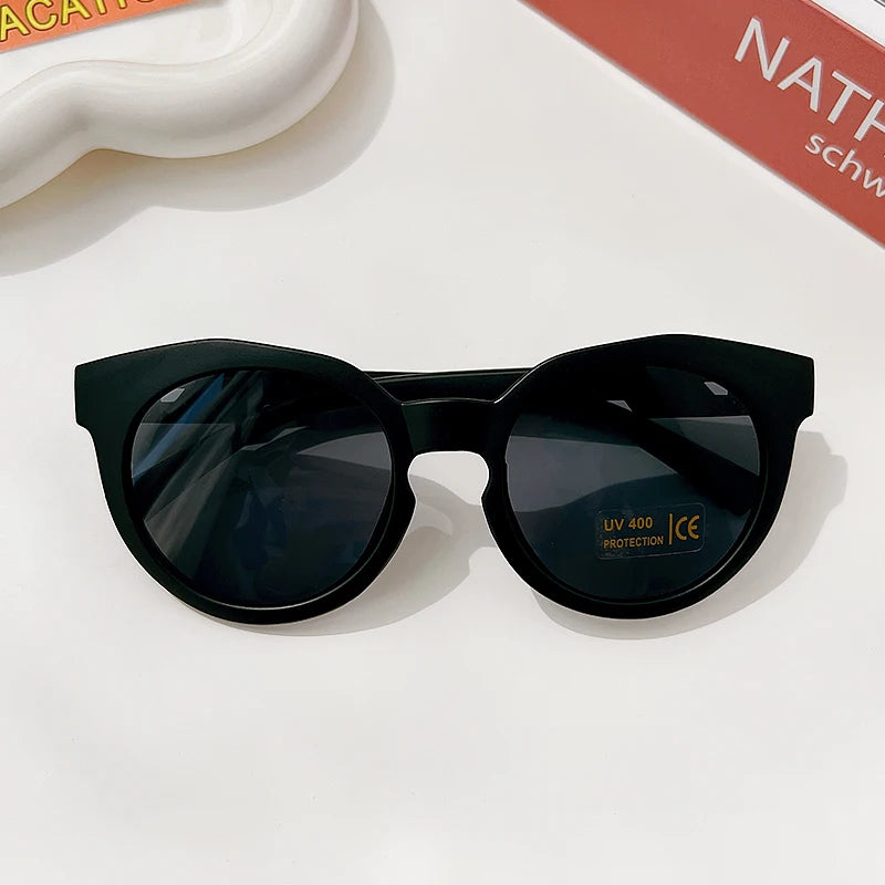 Black polarized sunglasses with a durable frame resting on a white surface.