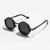 Runde polarisierte Sonnenbrille mit einstellbaren Tönungsgläsern auf weißem Hintergrund.