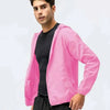 A male model wearing a bright pink waterproof windbreaker jacket over a black shirt and dark pants.