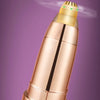 A close-up view of a metallic pink electric eyebrow trimmer with a yellow tip and a black band.