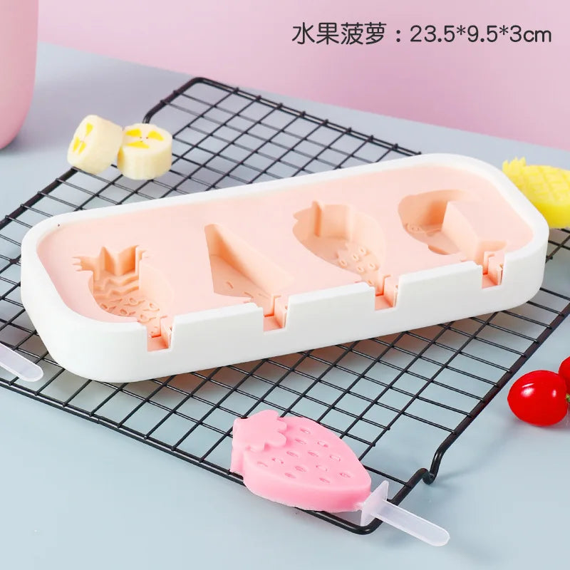 A white silicone popsicle mold tray with pink silicone popsicles and a red cherry visible on a black wire rack.