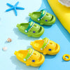 A collection of green and yellow kids shark clog sandals with anti-slip soles on a light blue background.