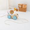 A wooden Montessori stacking train toy featuring an animal figure and blocks, with a string for play.