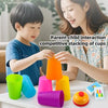 A child and a woman interact while stacking colorful plastic cups for a game.
