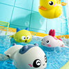 Cute yellow duck and white penguin bath toys floating in blue water with water spray bubbles