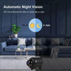 A black mini WiFi security camera is shown in a living room setting with a television screen displaying day and night vision 