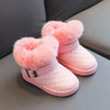 Pink winter snow boots with fluffy pink faux fur trim and a crystal bowknot detail