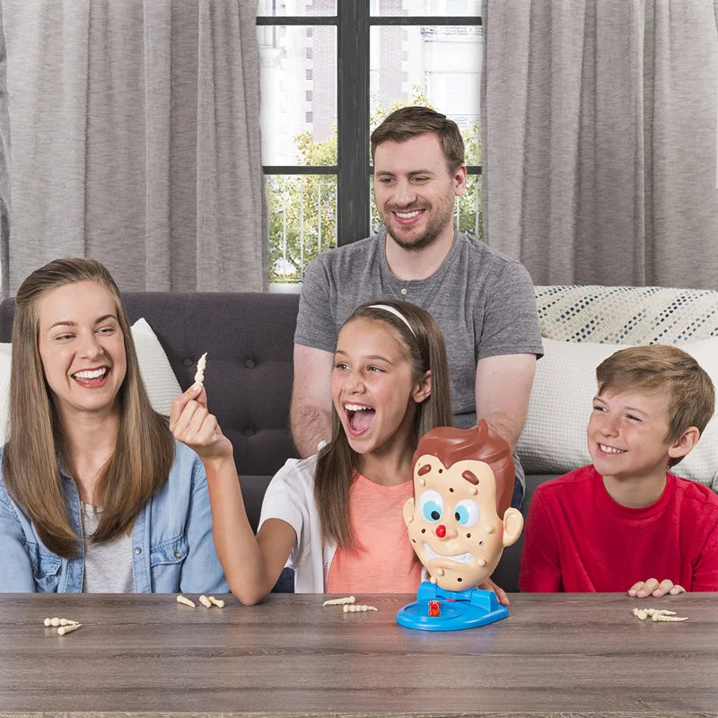 A family of four smiling around a table with an Acne Popping Squeeze Toy
