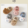 A collection of cozy plush bear baby shoes for first walkers in various colors and textures.