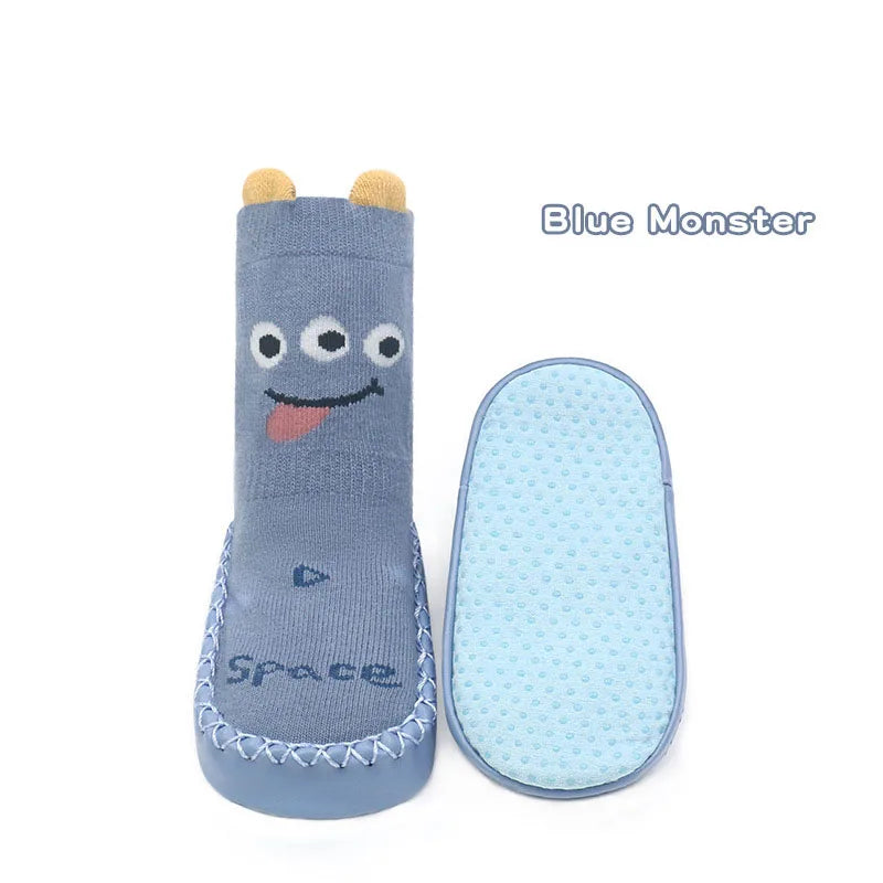 Blue Monster non-slip baby socks for toddlers with a cute face design and a matching silicone mat