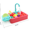 A red plastic pretend play kitchen sink set with a green faucet and water pouring into a basin.