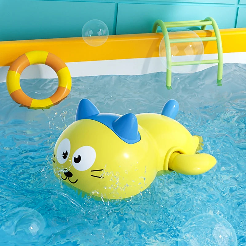A yellow duck bath toy is floating in blue water with a yellow ring and a green rack visible.