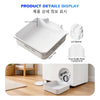 White washing machine filter drain tray with lid opener and flow guide plate displayed on a wooden floor.