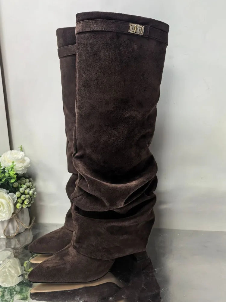 A pair of dark brown velvet knee-high boots with chunky heels and a metal buckle.