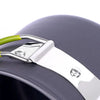 Silver strap and green handle of an ultralight camping cookware mess kit against a dark gray background.