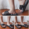 A pair of black acupoint massage slippers with rotating foot massage beads shown from various angles.