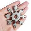 A hand holds an 18-in-1 compact multi-tool featuring various tools like a screwdriver and bottle opener.