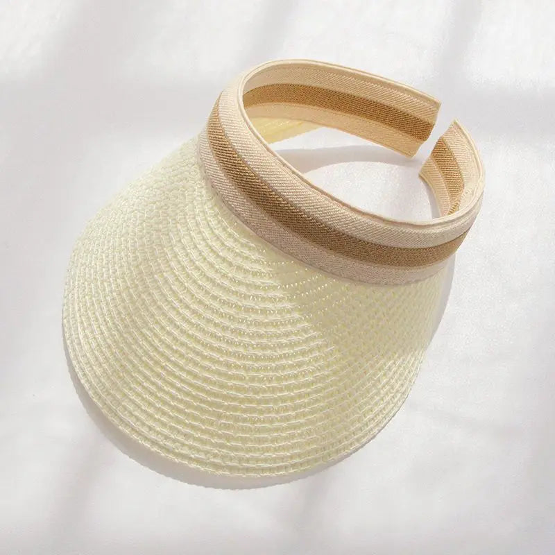 A woven straw sun hat with a light beige brim and band, shown against a white background.
