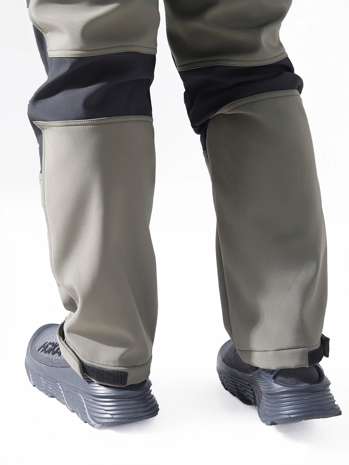 Close-up view of men's waterproof insulated fleece pants in gray and navy fabric.