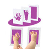 Inkless baby handprint and footprint keepsake kit showing various prints on white cards and purple background