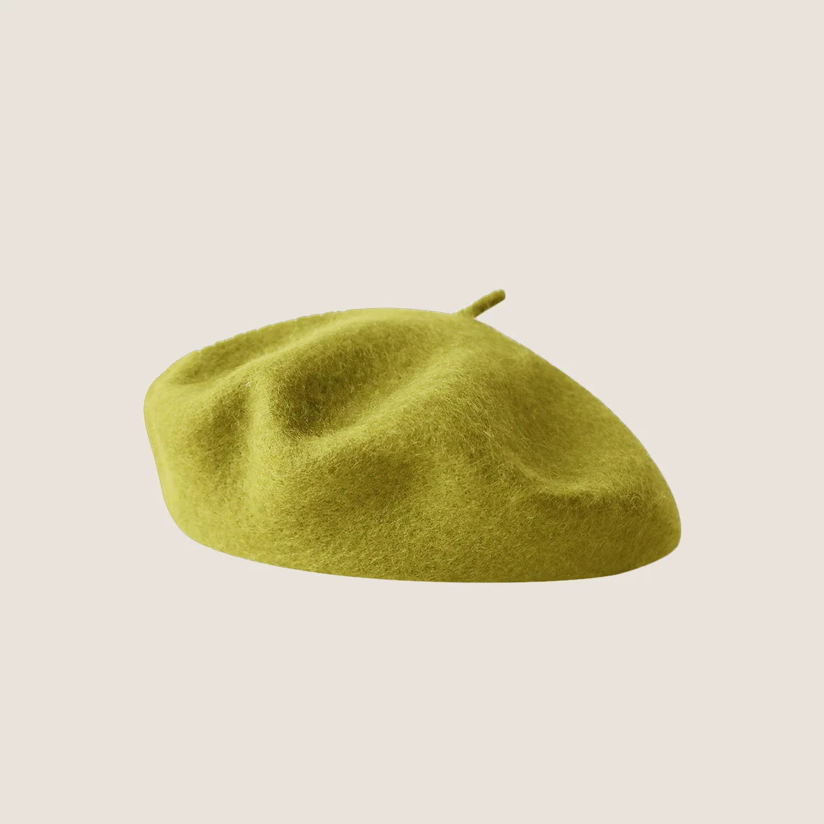 A close-up of a lime green wool beret hat with a slightly rounded shape.
