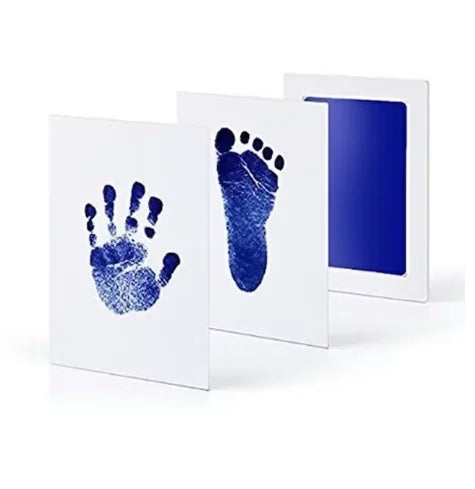 A white framed print showing a blue handprint and footprint on the left, next to a blue framed print with a dark blue backgro