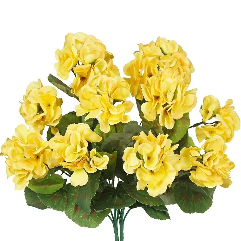 A bouquet of lifelike yellow artificial geranium flowers on green leaves.