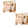 A beige portable heated shawl or electric blanket draped over a wooden chair.