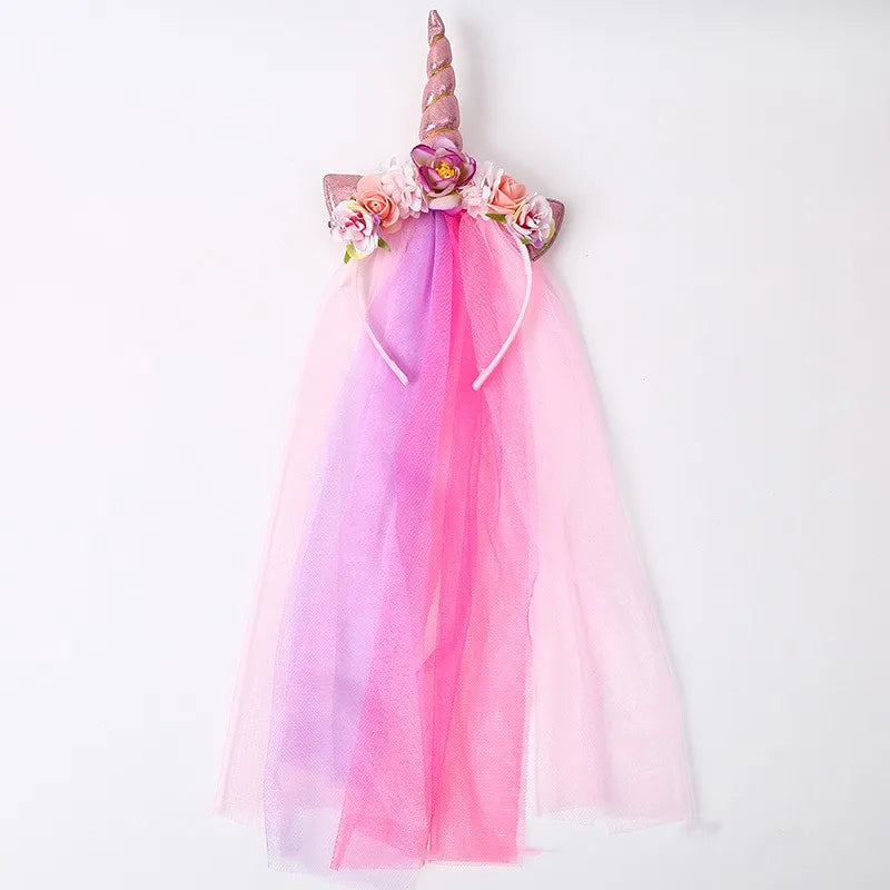 Pink and purple mesh unicorn headband with floral accents for a girl's party hair accessory