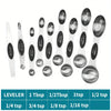 A set of nine stainless steel double-headed measuring spoons with various tablespoon and teaspoon sizes displayed on a white 