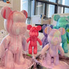 A collection of pink and colorful bear figurines made from DIY paintable resin in various shades and sizes.
