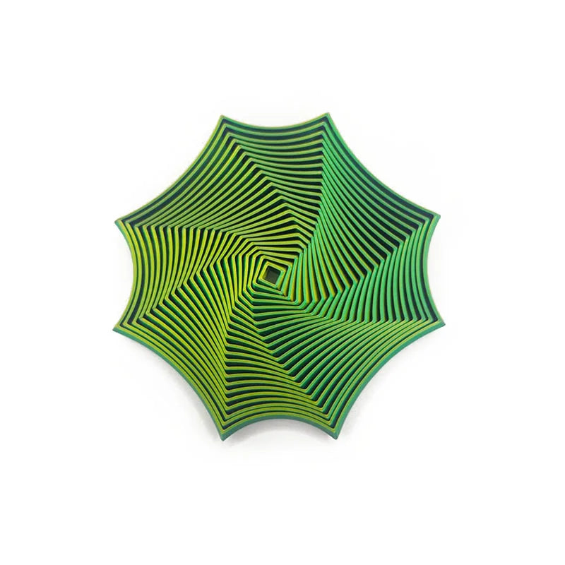 Geometrisk fikseleke med optisk illusjon og grønn, facetslipt overflate.