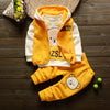 A yellow and white cartoon-themed kids' winter fleece pajama set including a hoodie, vest, and pants.