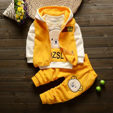 A yellow and white cartoon-themed kids' winter fleece pajama set including a hoodie, vest, and pants.