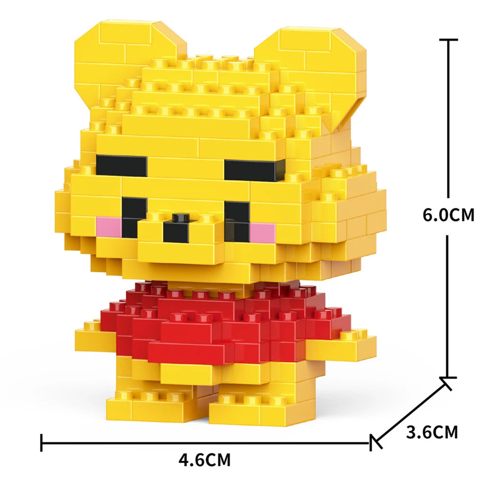 A yellow micro building block figurine of a bear with a red outfit and black facial features.