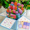 A colorful 3D pop-up love tree card featuring a couple silhouette and floral elements.