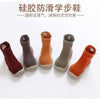 A collection of soft-soled baby first walker socks shoes in various earthy tones like maroon, brown, and orange.