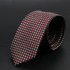 Corbata jacquard slim fit para hombre, diseño estampado en rojo oscuro y blanco, enrollada.
