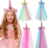 A girl wearing a pink unicorn mesh headband and colorful sheer fabric hair accessory