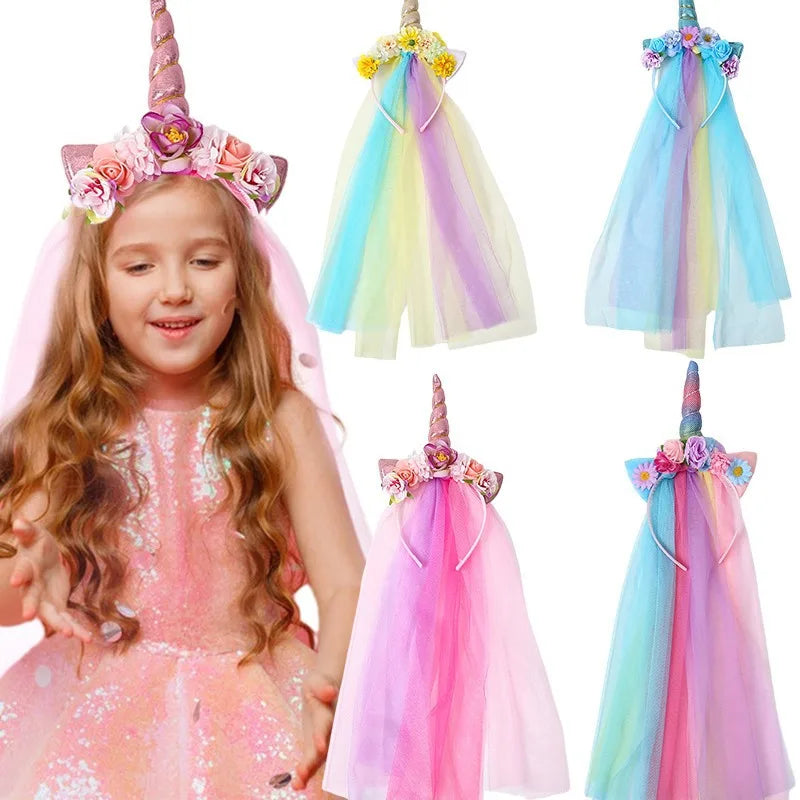 A girl wearing a pink unicorn mesh headband and colorful sheer fabric hair accessory
