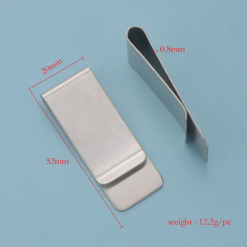 A silver metal tie clip shown next to a measuring scale, indicating its dimensions and weight.
