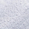 Close-up of a white non-woven fabric with water droplets on it.