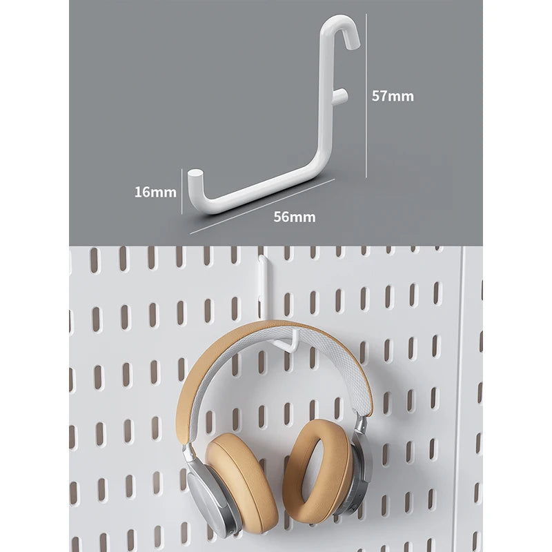 A pair of beige over-ear headphones resting on a white modular pegboard panel.