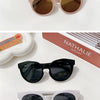 A collection of sunglasses in various colors and styles, including aviator, round, and square frames.