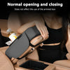 A hand is using a car center console organizer with an armrest cushion and cup holder on a vehicle.